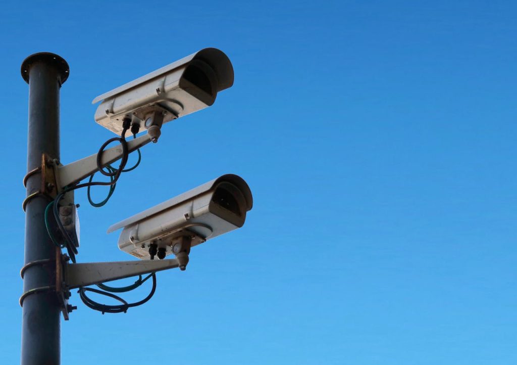 Surveillance cameras against blue sky