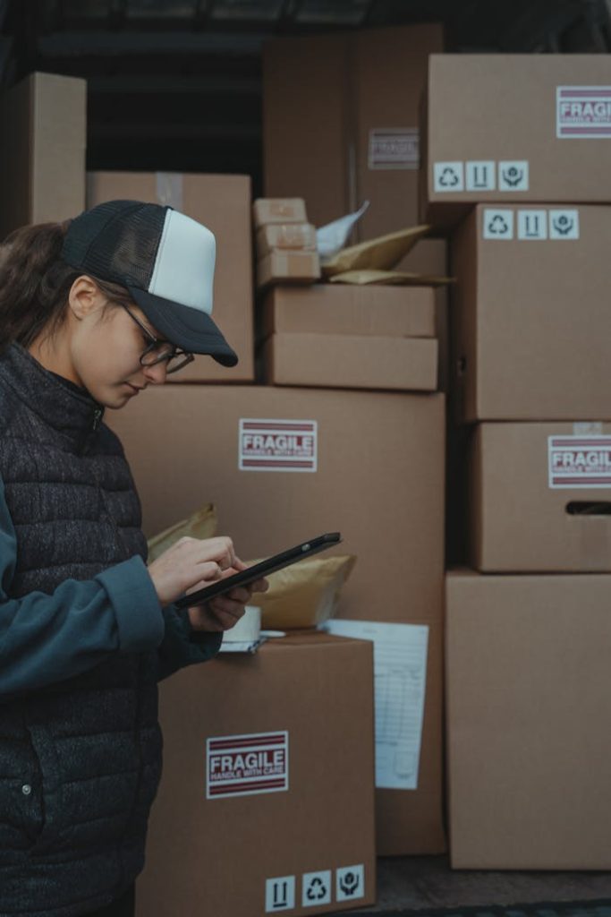 Woman in Black Jacket Holding Black Tablet Computer